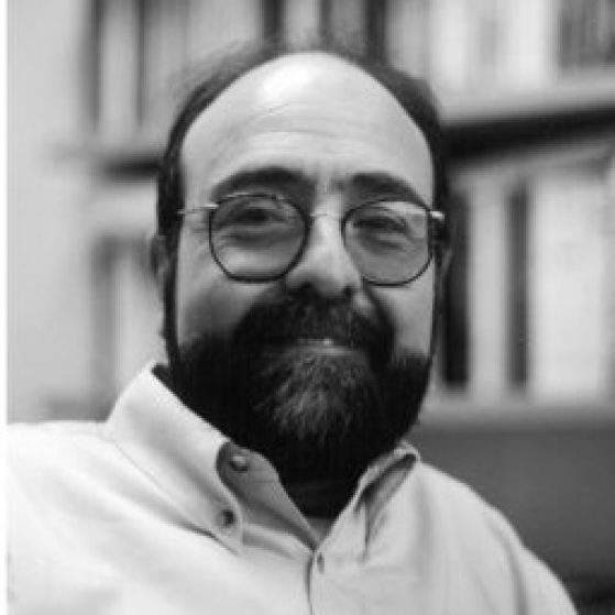 A black and white headshot of Javier Sanjines wearing glasses and a collared shirt.
