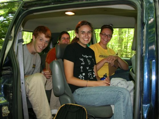 students, including Fortino, in a minivan in the woods.