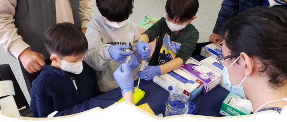 Scientist helping child participate in a research experiment