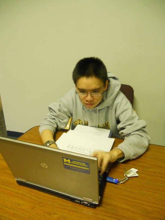 Shao Wei Chia sitting in front of a laptop