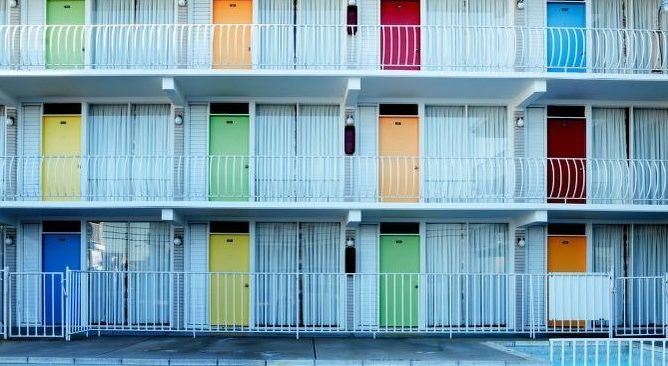 a 3-story motel with many colorful doors