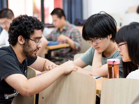 UM chemistry student conferring with Chinese chemistry student