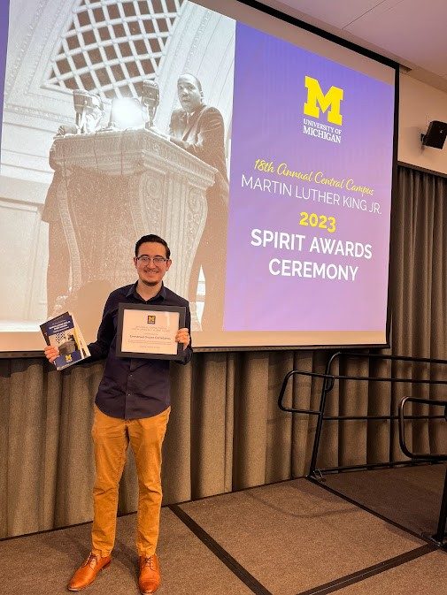 Emmanuel Orozco Castellanos holding his award at the 2023 Spirit Award Ceremony