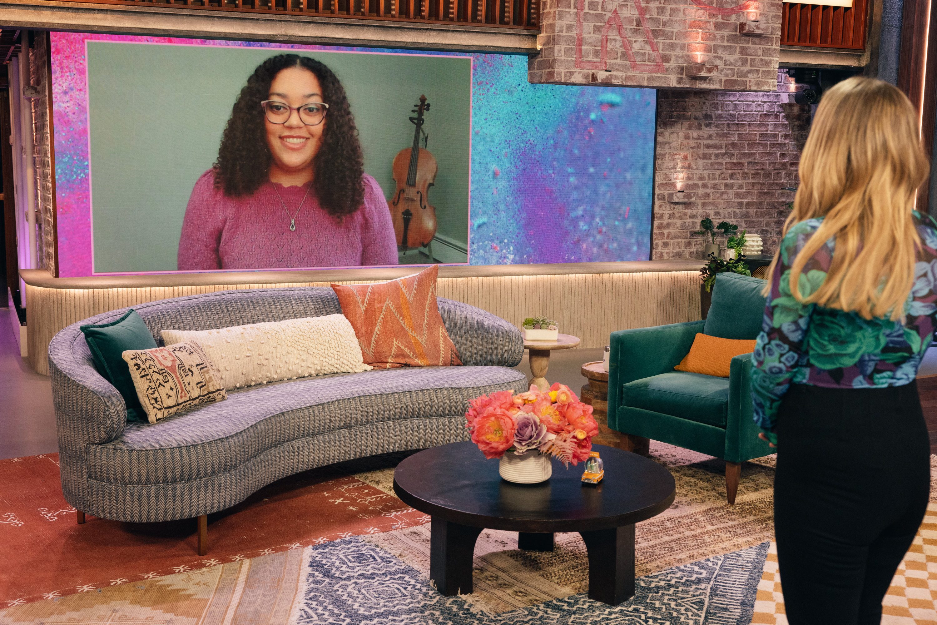 Lynnea Jackson appears on a large screen on the set of The Kelly Clarkston Show