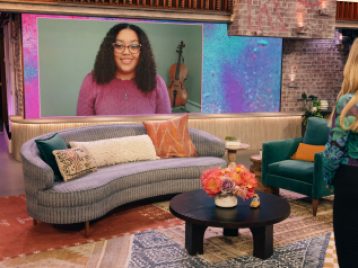 Lynnea Jackson appears on a large screen on the set of The Kelly Clarkston Show