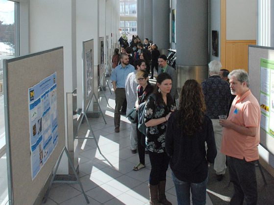Graduate students and postdocs from various universities presented their research at the lunchtime poster session in the Palmer Commons atrium. Images this page: Dale Austin.
