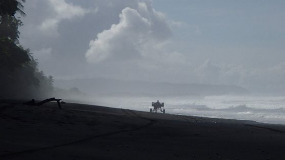 Solitude, Corcovado, Costa Rica. Man riding in a horse drawn cart up the beach. Image: Gail Kuhnlein