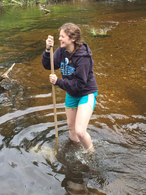 Maryellen Zbrozek collecting river samples during a General Ecology lab at the U-M Biological Station.