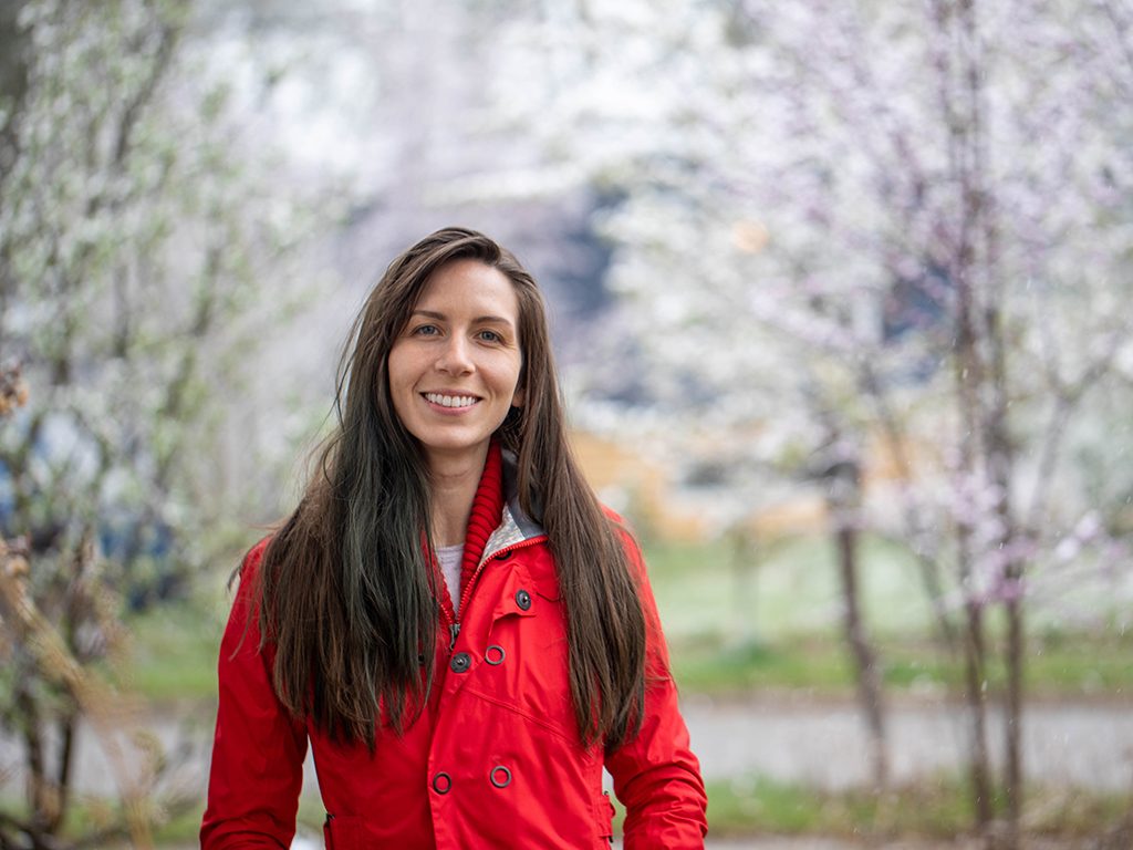 Giorgia Auteri in a red jacket standing in front of trees blurred in the background. Image: Isa Betancourt