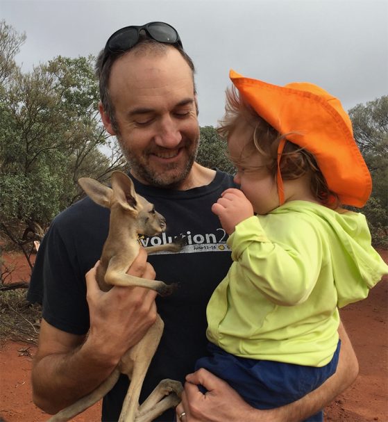 Dan Rabosky holding a joey and daughter, Maya, age 16 months, during fieldwork on lizard ecology in a remote area of Western Australia. Image: Alison Davis Rabosky