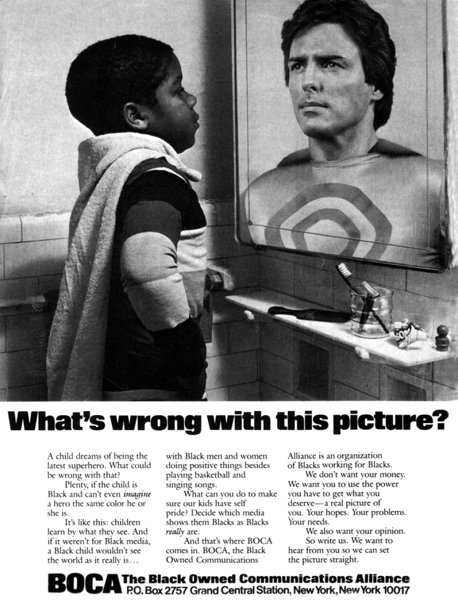 A black-and-white newspaper advertisement that depicts a young black boy wearing cape who is looking into a mirror where a white Christopher Reeve as Superman is there, looking back. Text below the image says, What is wrong with this picture?