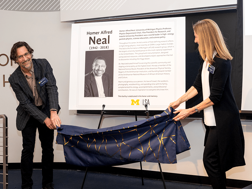 Physics Department chair David Gerdes and LSA Dean Anne Curzan unveil a new portrait of Homer A. Neal.