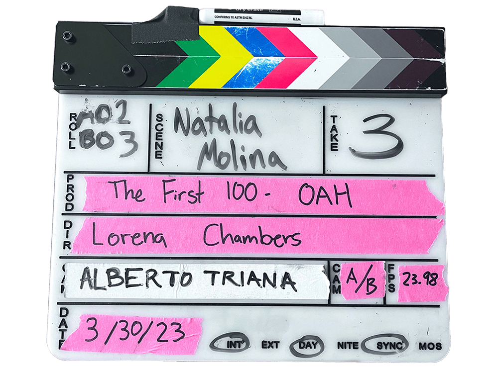 A movie clapperboard has readouts about the production of Lorena Chambers’s project The First 100.
