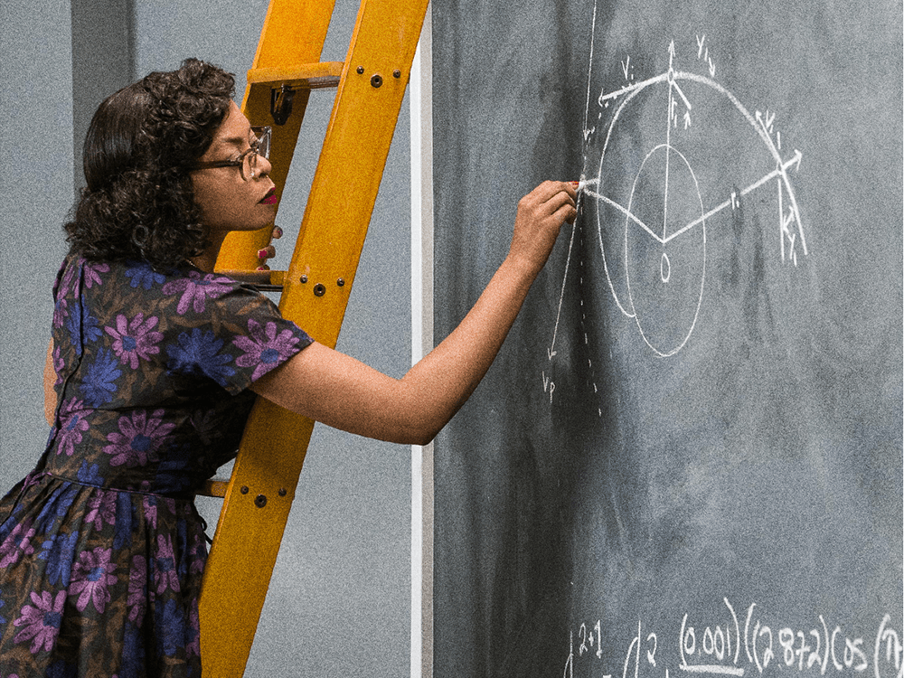 A photo of actress Taraji P. Henson in the movie "Hidden Figures," standing on a ladder and writing mathematical calculations on a chalkboard.