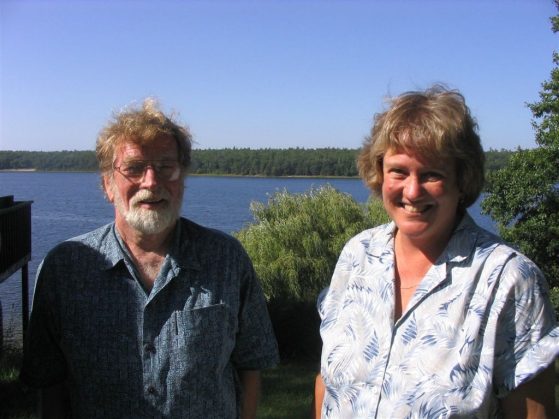 Brian Hazlett and Cathy Bach are pictured at the U-M Biological Station in this recent photo. It's a sunny day. You can see Douglas Lake in the background.