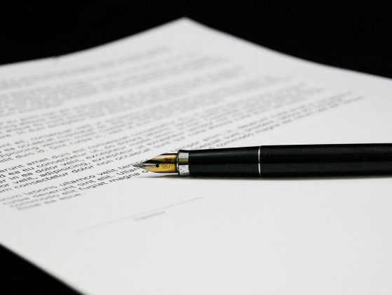 stock image of a fountain pen on a paper with typing