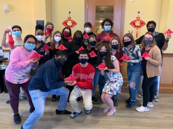 17 GSP students hold up their art projects at the Chai Chatter Lunar New Year celebration