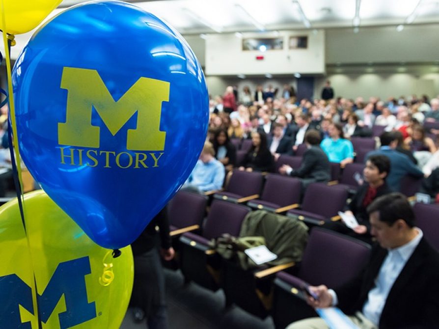 U-M History balloons foreground the incoming crowd at 2016 History Commencement