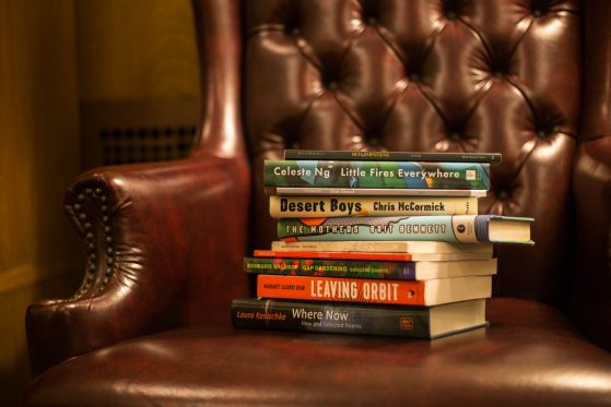Stack of Hopwood Winners' books on a red leather chair