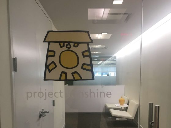 Glass door with project sunshine logo