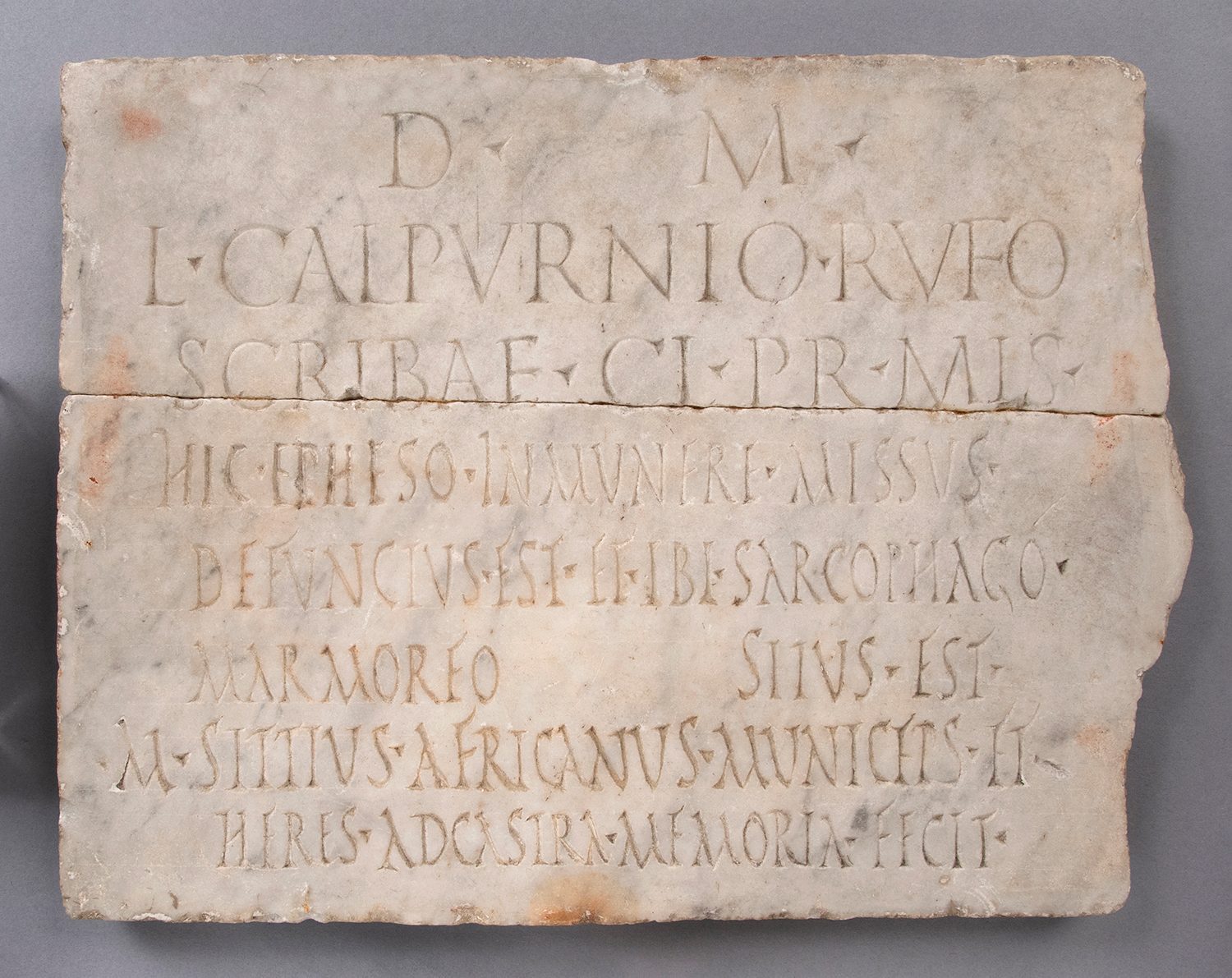Roughly rectangular slab of white marble with Latin inscriptions.
