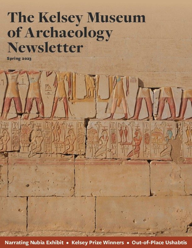 Cover of the Spring 2023 edition of the Kelsey Museum Newsletter, featuring wall of tan stacked bricks with carved hieroglyphics.