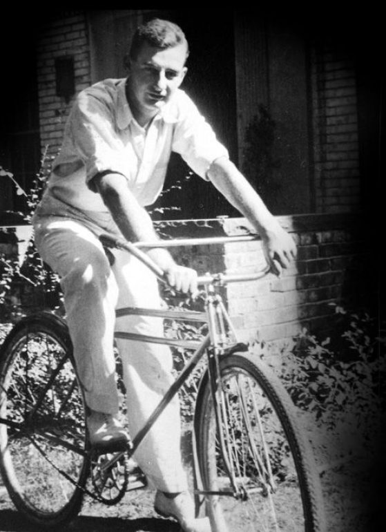 Black and white photo of a young man, Raoul Wallenberg, sitting on a bicycle