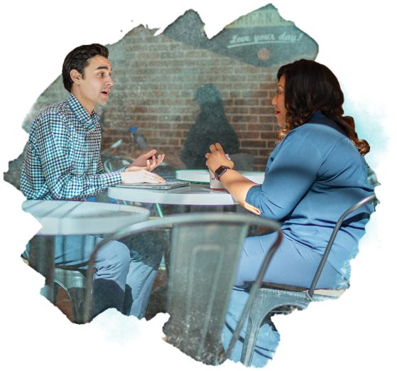 Student speaking with an alum in a cafe