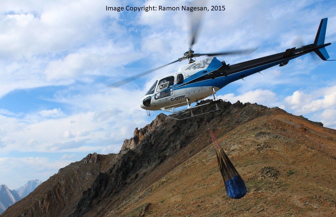 image of fossil remains being airlifted by helicopter 
