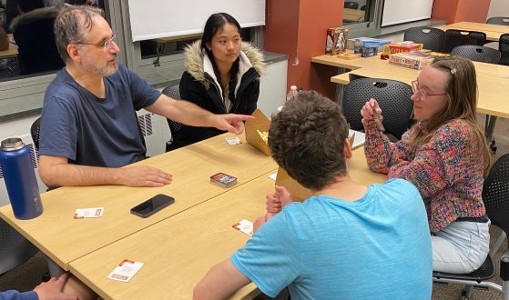 A professor and students play a card game