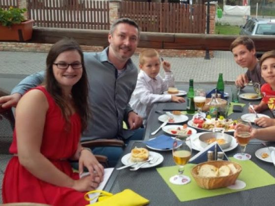 Lizzie (bottom left) enjoying dinner with her host family.