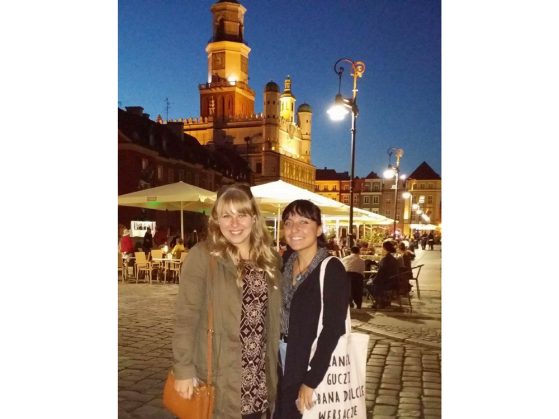Gabrielle Wasilewski (on the left) with a friend from Turkey at an entrance to the Stary Rynek of Poznań (Ratusz building  in background)