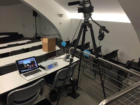 Classroom with video camera on tripod. Camera is connected to laptop.