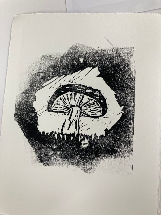 A black and white woodblock print of a mushroom