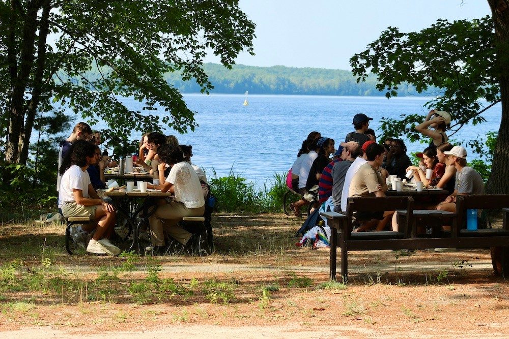 Eating at tables along lake