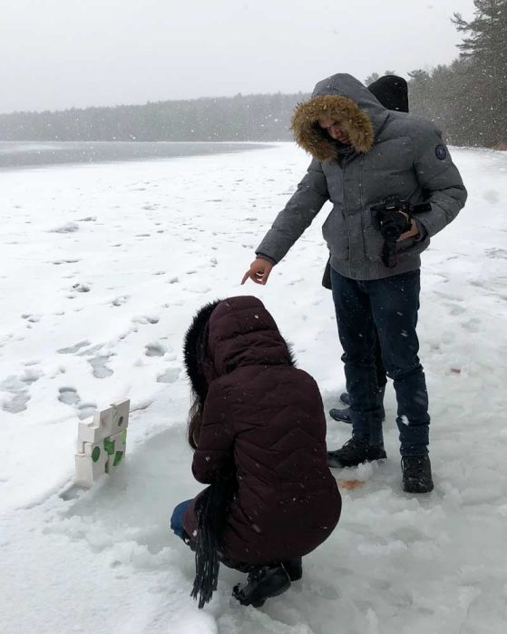 Three students gather around their study of green resin and Plaster of Paris installed on Douglas Lake ice.