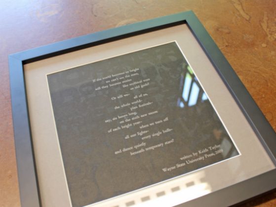 A framed poem is shown.