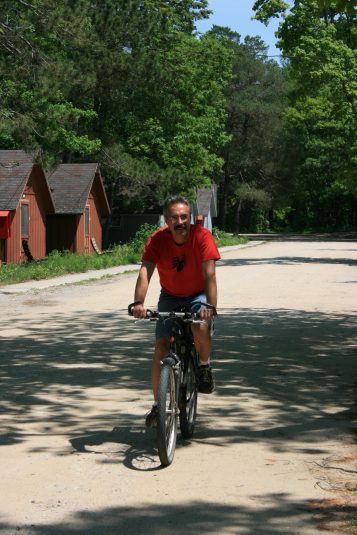 Tony rides his bike through camp.
