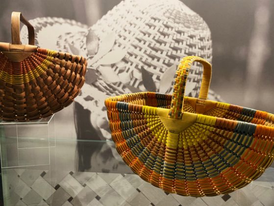 Two Anishinaabe Baskets on display in UMMNH collections case