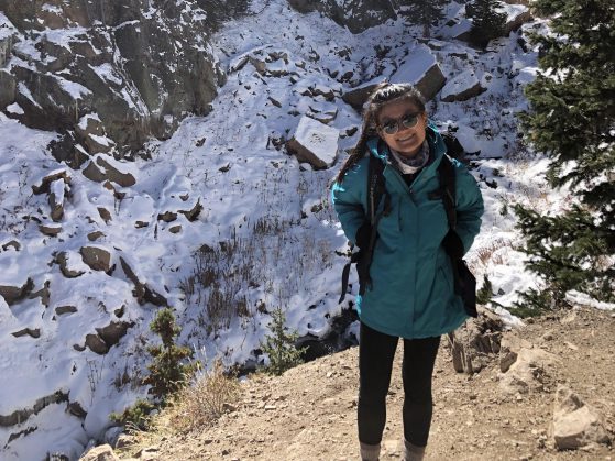 Connie Truong hiking in a snow covered mountain trail